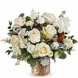 White rose bouquet in a woven gold vase