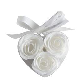 Heart-shaped box with three white roses and a ribbon bow