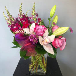 Pink and white floral arrangement in a clear glass vase