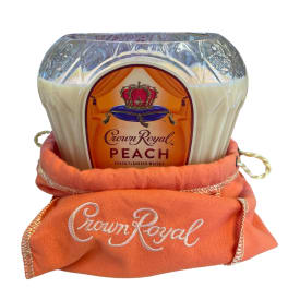 Crown Royal Peach whiskey bottle wrapped in an orange cloth bag