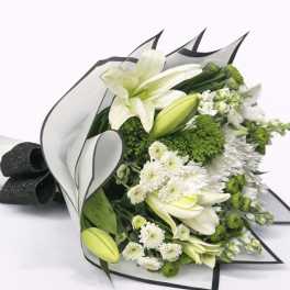 White lilies and green-white chrysanthemums wrapped in black-edged paper