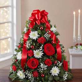 Christmas tree-shaped floral arrangement with red roses and white daisies