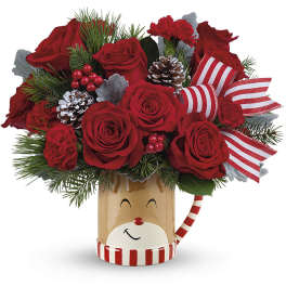 Red roses in a festive reindeer mug with pinecones and striped ribbon