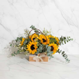 Sunflower arrangement in a kraft box with a ribbon