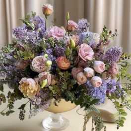 Pastel bouquet of roses and hydrangeas in a pedestal vase