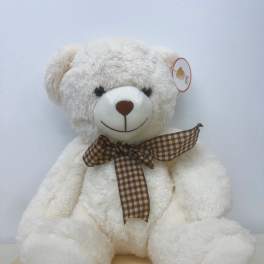 White teddy bear with a brown plaid ribbon bow
