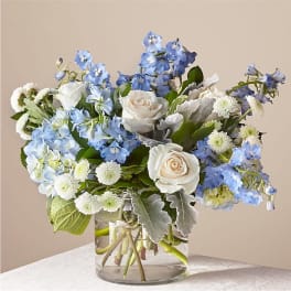 Blue and white bouquet in a clear glass vase