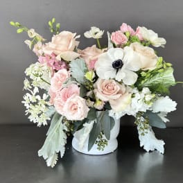 Blush and white floral arrangement in a white vase