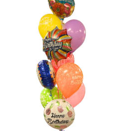 Cluster of colorful birthday balloons with printed messages