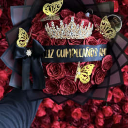 Bouquet of red roses with a jeweled crown and black ribbon