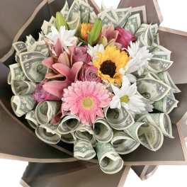 Bouquet of mixed flowers wrapped with rolled dollar bills