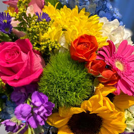 Colorful mixed bouquet with roses, sunflowers, and hydrangeas