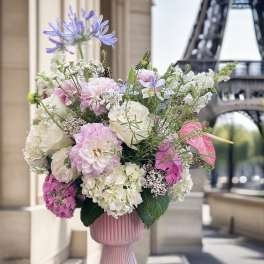 Pink and white floral arrangement in a ribbed vase