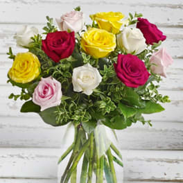 Bouquet of multicolored roses in a clear glass vase