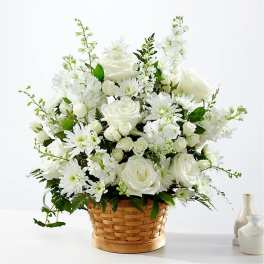 White floral arrangement in a woven basket