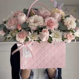 Pink flower box arrangement with roses, carnations, and daisies