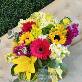 Bright mixed bouquet with gerbera daisies, sunflowers, lilies, and white blooms