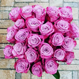 Bouquet of pink roses against a stone wall