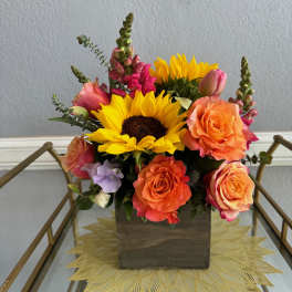 Sunflower and rose arrangement in a wooden box