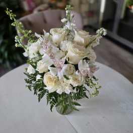 White rose bouquet in a clear glass vase