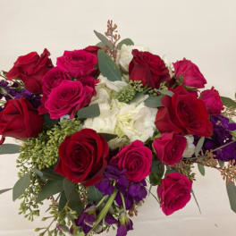 Bouquet of red and pink roses with white flowers and purple accents