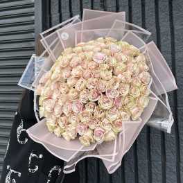Large bouquet of pale pink roses wrapped in pink paper