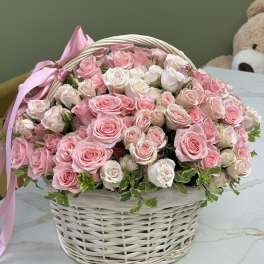 Basket of pink and white roses with a pink ribbon