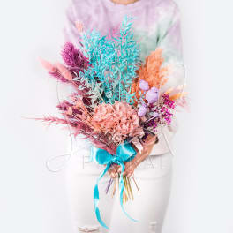 Colorful bouquet with pastel dried flowers tied with a blue ribbon
