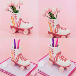 Pink tulips in a roller skate-shaped vase and a matching pen holder