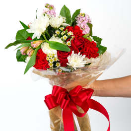 Bouquet of red and white flowers wrapped with a red ribbon