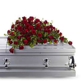 Red rose spray on a silver casket