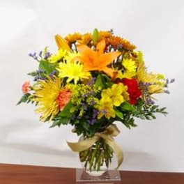 Colorful bouquet of mixed flowers in a clear vase