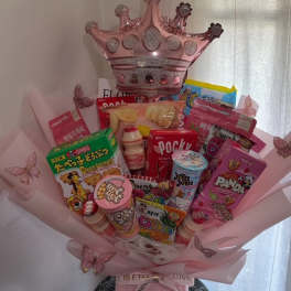 Pink gift bouquet with snacks, candy, and a crown balloon