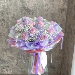 Bouquet of pink roses with white baby's breath and lavender wrapping