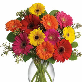 Colorful gerbera daisy bouquet in a clear glass vase