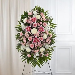 Standing floral spray with pink and white flowers on an easel