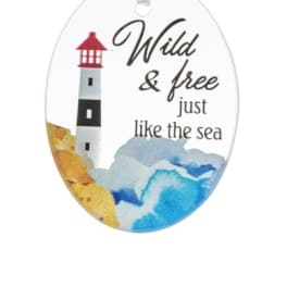 Oval ornament with a lighthouse and the words "Wild & free just like the sea"