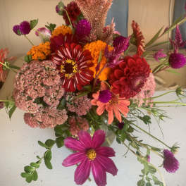 Mixed bouquet with red, pink, orange, and purple flowers