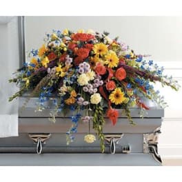 Colorful floral casket spray with roses and daisies