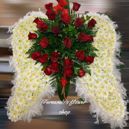 Standing angel wing spray of white daisies with feather edges and red roses in the center