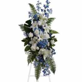 Tall blue and white floral standing spray on an easel