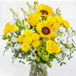 Yellow bouquet with sunflowers and roses in a glass vase
