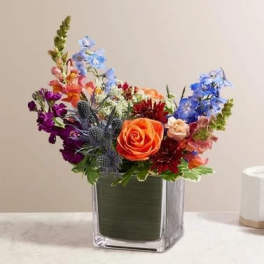 Colorful mixed bouquet in a square glass vase