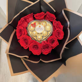 Red rose bouquet with a heart-shaped chocolate box in black wrap