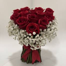 Bouquet of red roses with white baby's breath tied with a red ribbon