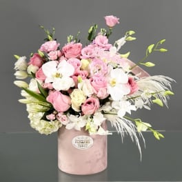 Pink and white bouquet in a blush hatbox with orchids and roses