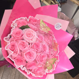 Bouquet of pink roses wrapped in bright pink paper