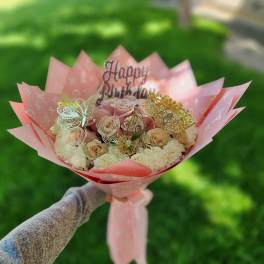 Pink bouquet of roses and carnations with butterfly toppers and a Happy Birthday sign