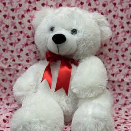 White teddy bear with a red ribbon on a heart-patterned pink background