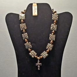 Beaded necklace displayed on a black bust stand